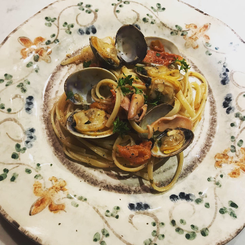 Linguine pasta with clams, squid, and cherry tomatoes